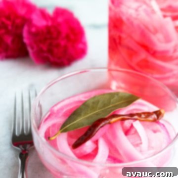 Mexican Pickled Onions 9 Bowl of Mexican pickled onions with a jar of pickled onions behind it, illustrating the finished product.