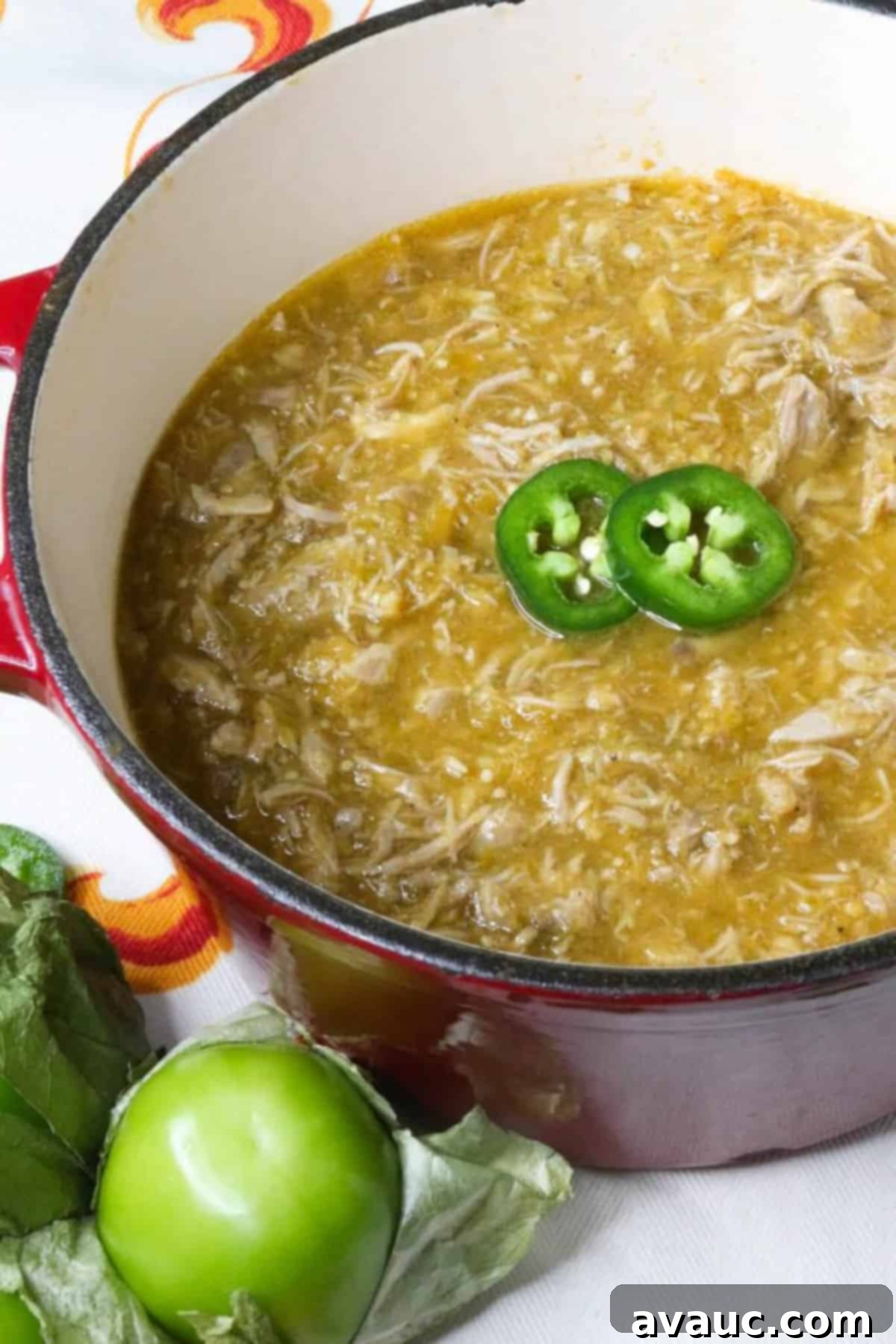Zesty Salsa Verde Pulled Pork 2 Salsa Verde Pulled Pork in a small, red Dutch oven