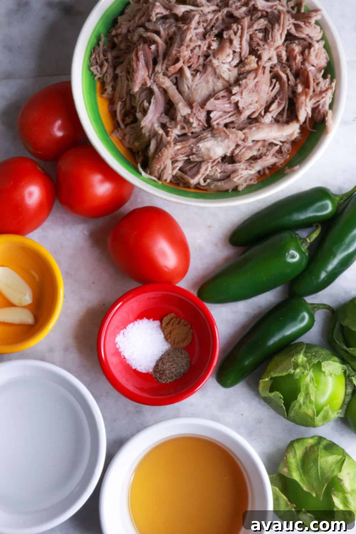Zesty Salsa Verde Pulled Pork 3 Bowl of shredded pork, some tomatoes, jalapeños, tomatillos, a bowl with garlic cloves, another with chicken broth, another with water, and another with spices.