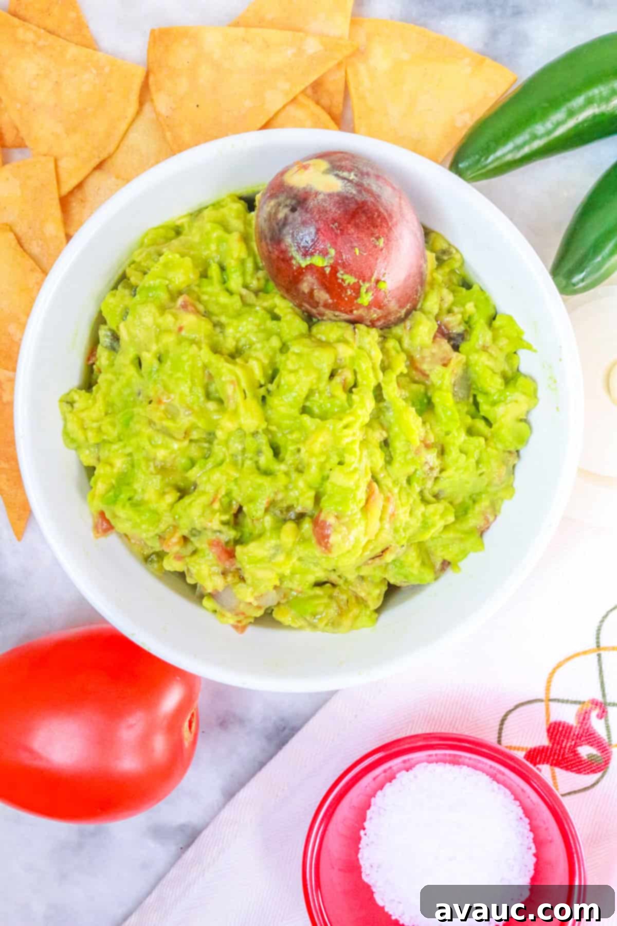 Smoky Simplicity Guacamole with Only Four Ingredients 10 Fire Roasted Guacamole surrounded by tortilla chips and vegetables