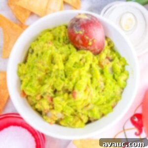 Smoky Simplicity Guacamole with Only Four Ingredients 11 Fire Roasted Guacamole surrounded by tortilla chips and vegetables