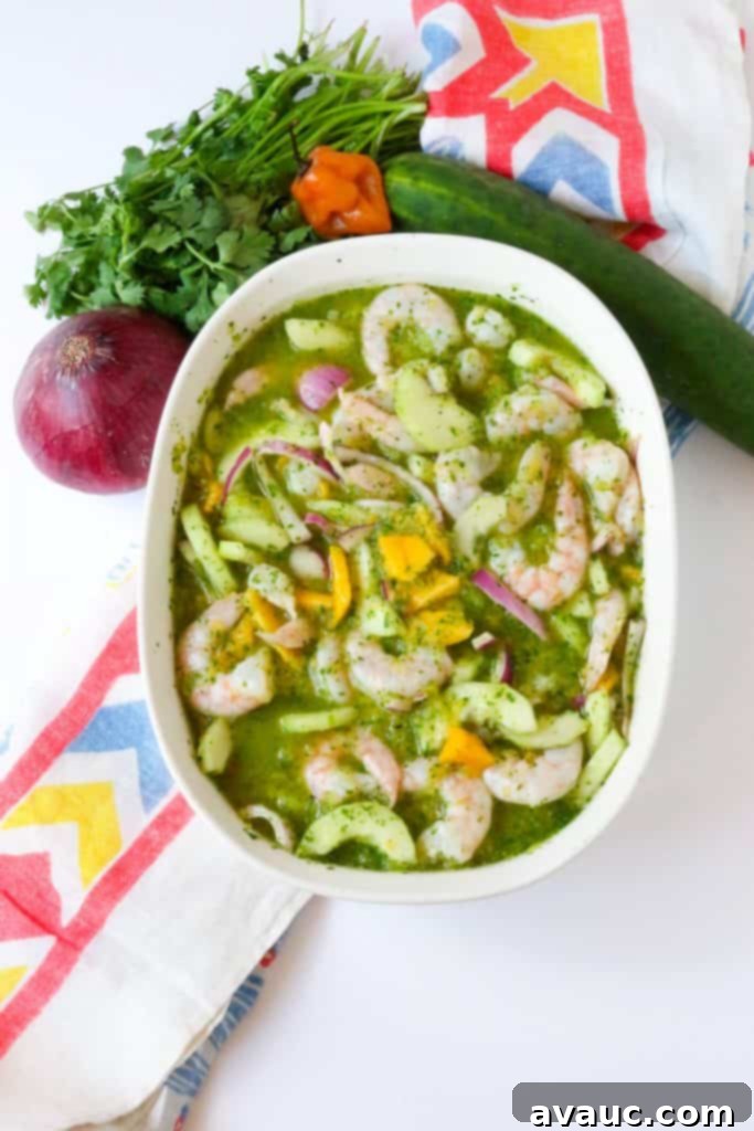Vibrant Shrimp Aguachile with Mango served in a bowl, showcasing fresh ingredients and green sauce.