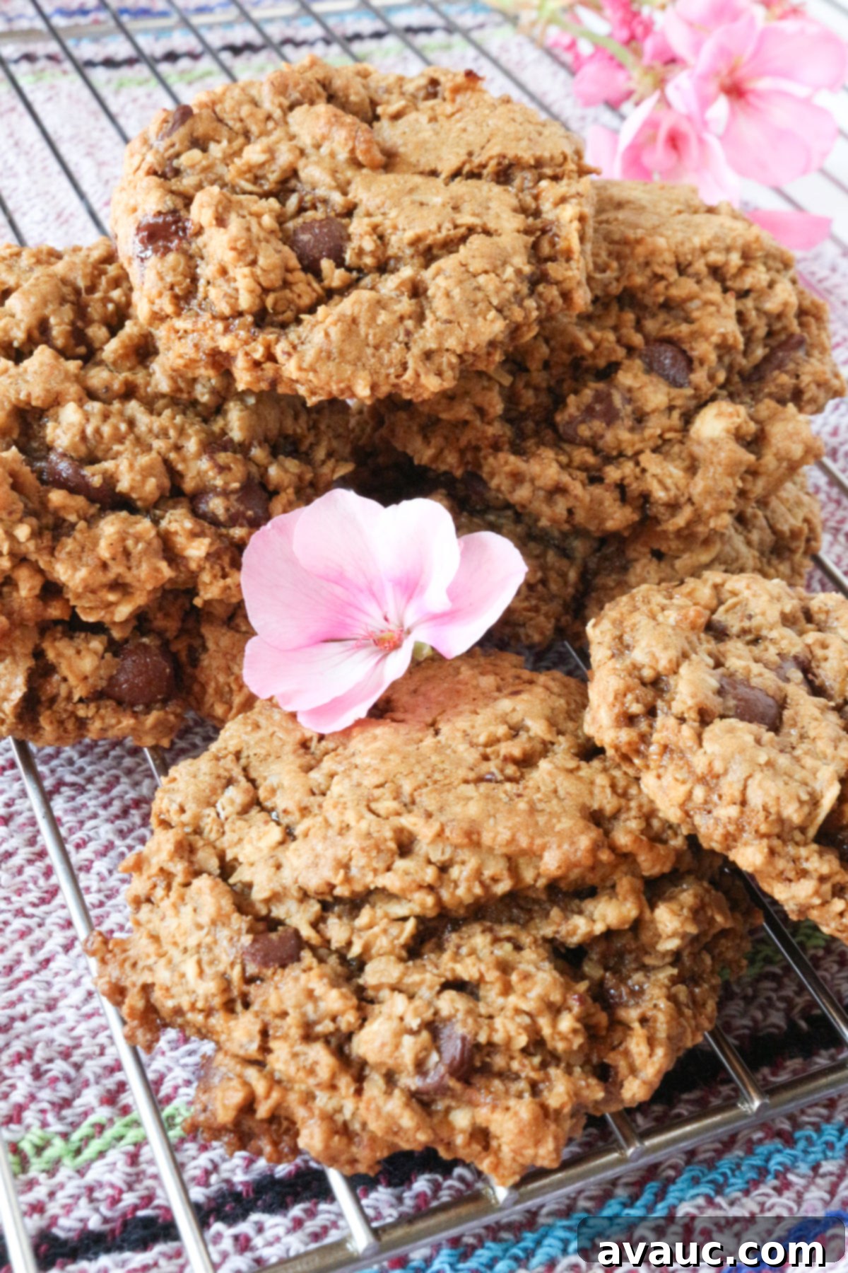 Soft Chewy Vegan Oatmeal Chocolate Chip Cookies 5 Close-up of Vegan Oatmeal Chocolate Chip Cookies on a Wire Rack with a Decorative Flower