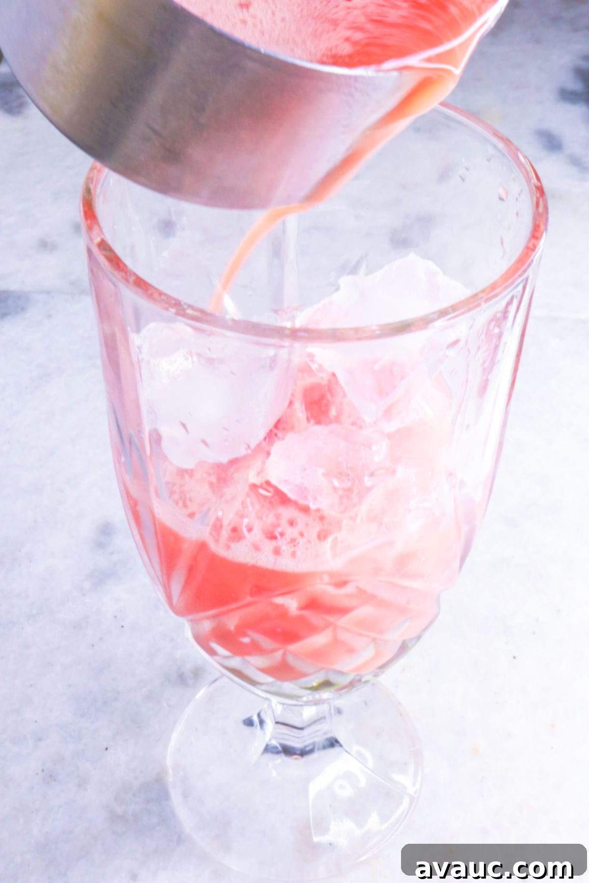 Pouring watermelon juice in glass
