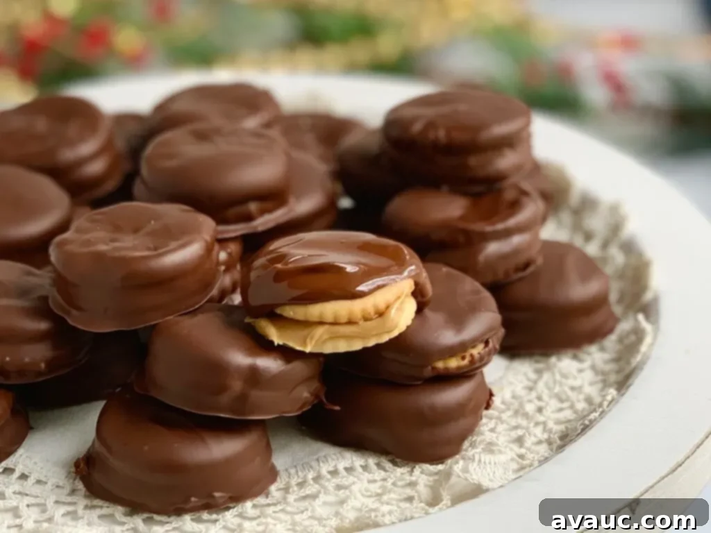 A plate generously filled with peanut butter sandwiches between crisp crackers, meticulously dipped in melted chocolate for a delightful sweet and savory treat.