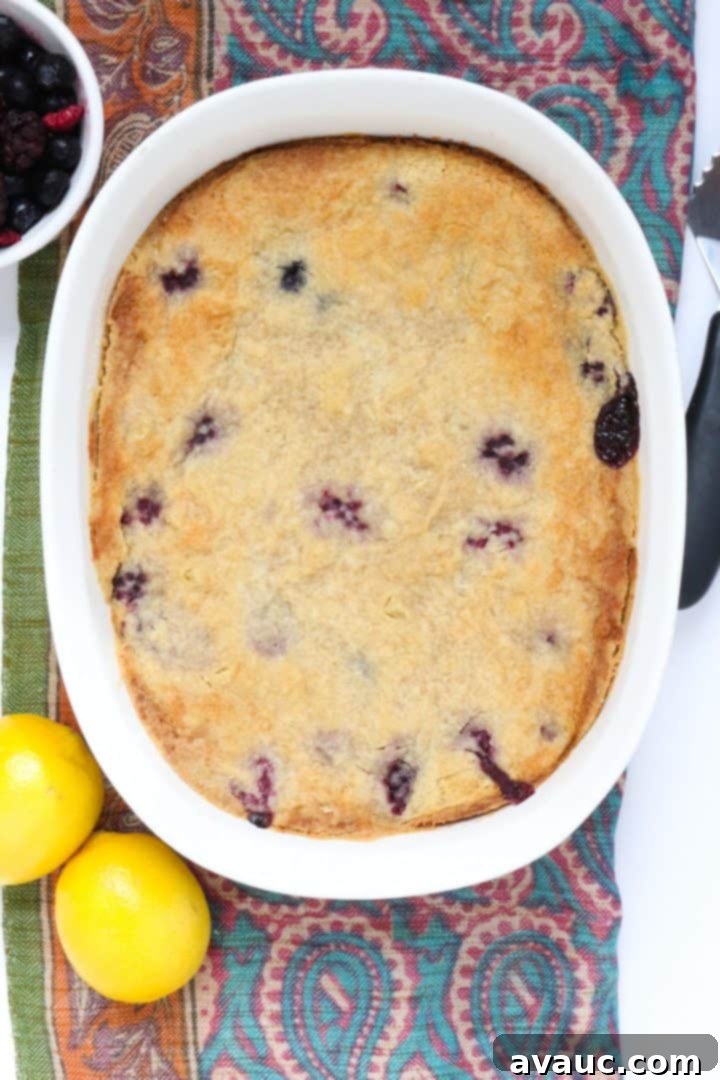 Effortless Gluten-Free Dump Cake 6 Gluten-Free dump cake in white baking dish with berries and lemons beside it