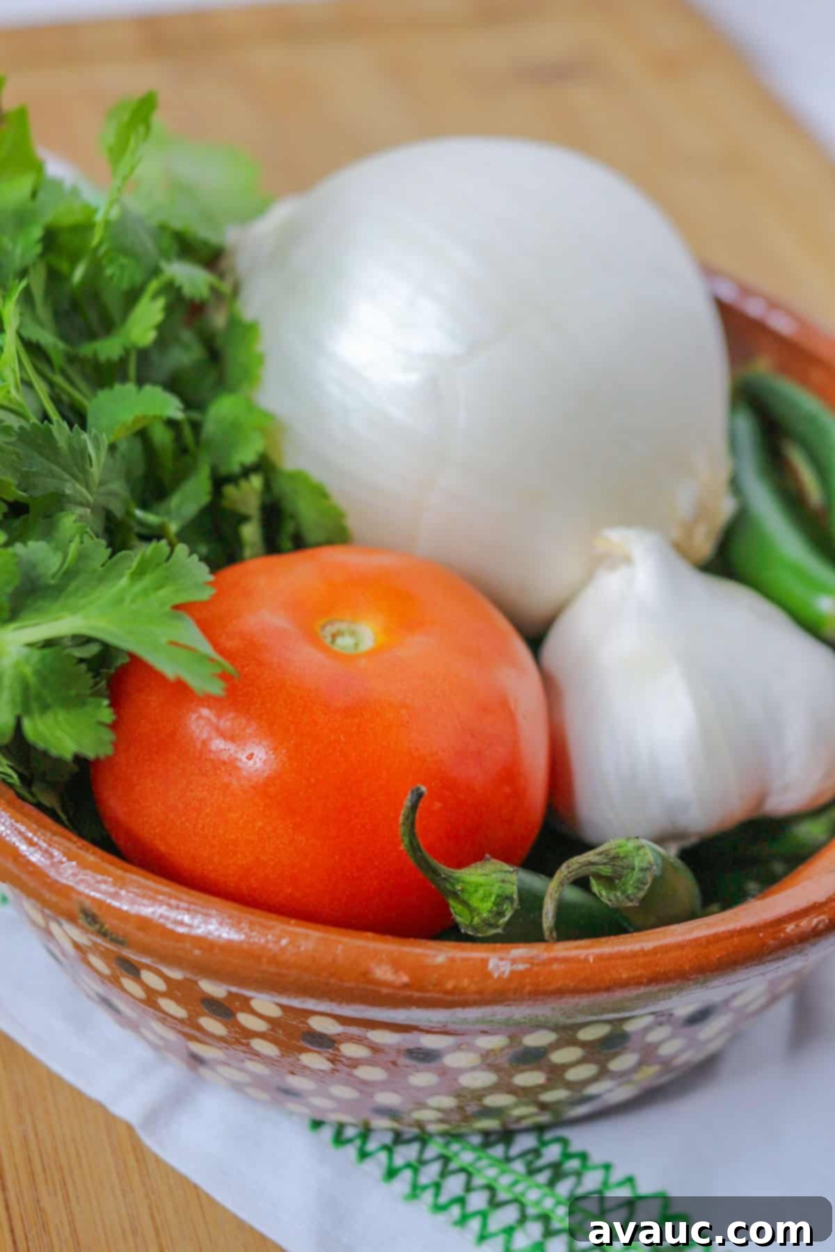 Onion, cilantro, tomato, garlic and serranos in a bowl