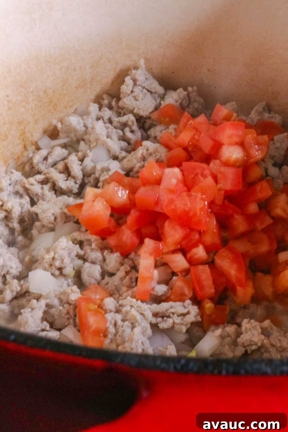 Diced tomatoes in a pot with ground turkey