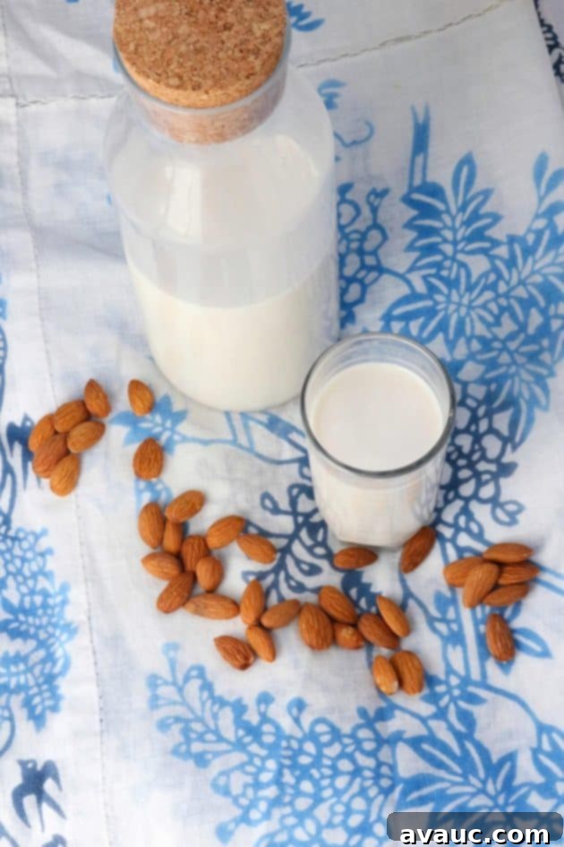 Glass of Healthy Homemade Almond Milk (Paleo & Whole30) and bottle of almond milk #homemadealmondmilk