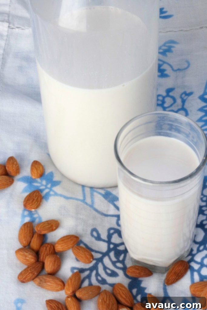 Glass of Healthy Homemade almond milk (Paleo & Whole30) and bottle of almond milk #homemadealmondmilk