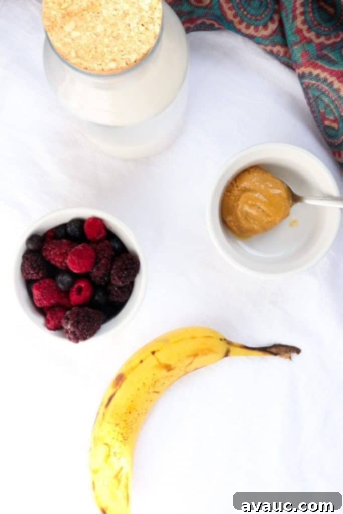 Ingredients for Healthy PB&J Smoothie: Peanut Butter, Mixed Berries, Banana, Oat Milk