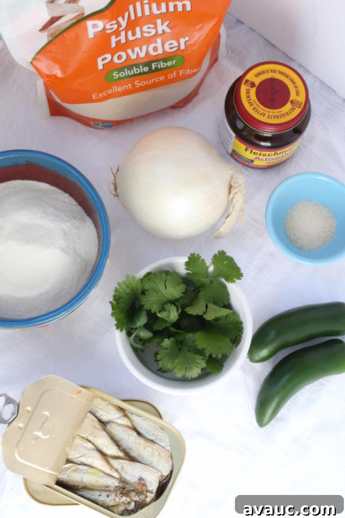 Savory Gluten-Free Sardine Empanadas 3 Psyllium husk powder, yeast, an onion, a bowl office flour, cilantro, salt, jalapeños and a can of sardines