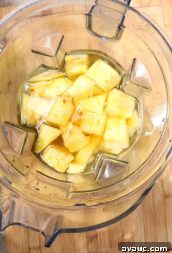 Fresh Pineapple Cooler 5 Step 2: Chopped pineapple chunks are added to a blender with cold water.