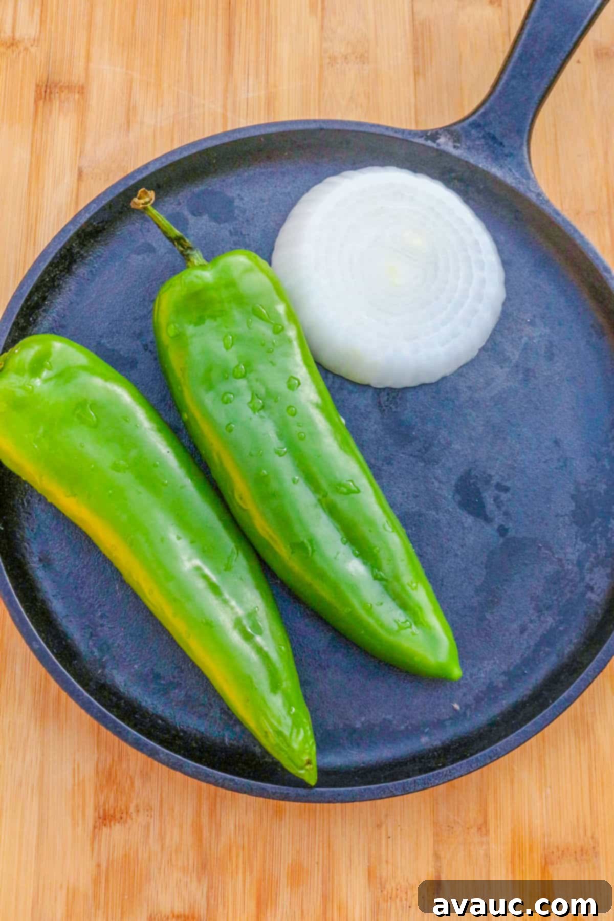 Smoky Roasted Green Chile Guacamole 6 Green chiles and onion charring on a comal, releasing smoky aromas