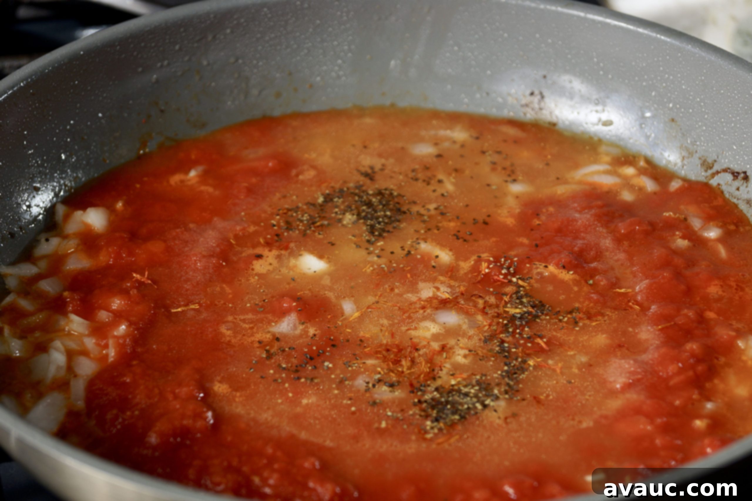 Cauliflower Mexican Arroz con Pollo 5 Crushed tomatoes and spices simmering for Mexican cauliflower arroz con pollo