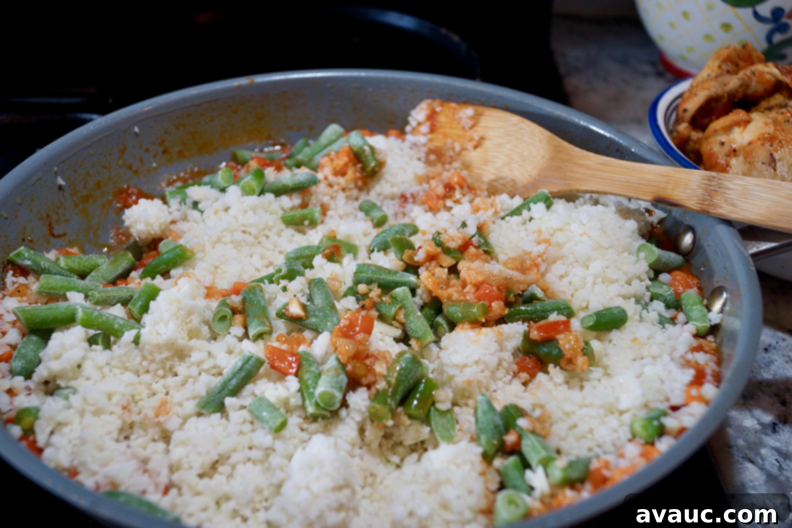 Cauliflower Mexican Arroz con Pollo 7 Frozen cauliflower rice and green beans added to the pan