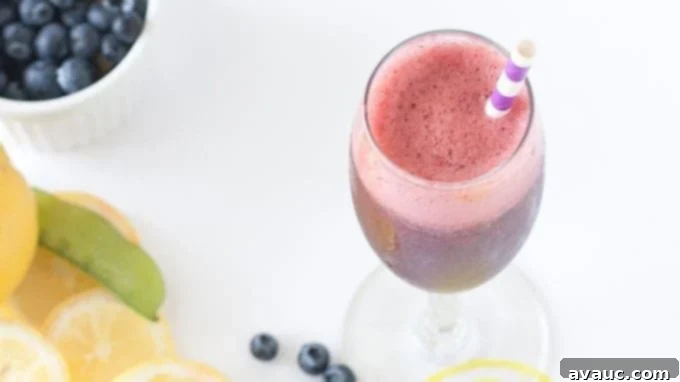 Two glasses of homemade Blueberry Lemon Moscato Spritzers, garnished and ready to enjoy.
