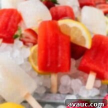 Zesty Strawberry Lemonade Pops 9 Vibrant homemade strawberry lemonade popsicles ready to be enjoyed.