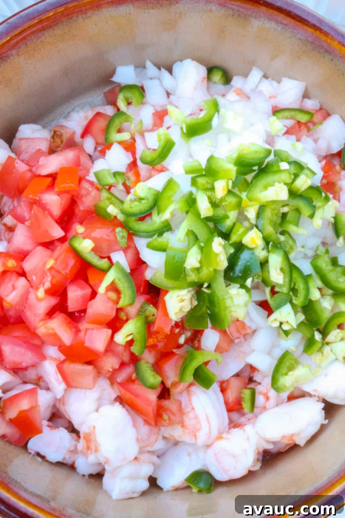 Zesty Mexican Shrimp Ceviche 5 A bowl with diced shrimp, tomatoes, onion and jalapeño