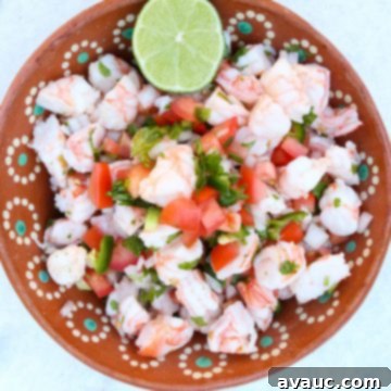 Zesty Mexican Shrimp Ceviche 8 Shrimp Ceviche in a brown bowl with a lime.