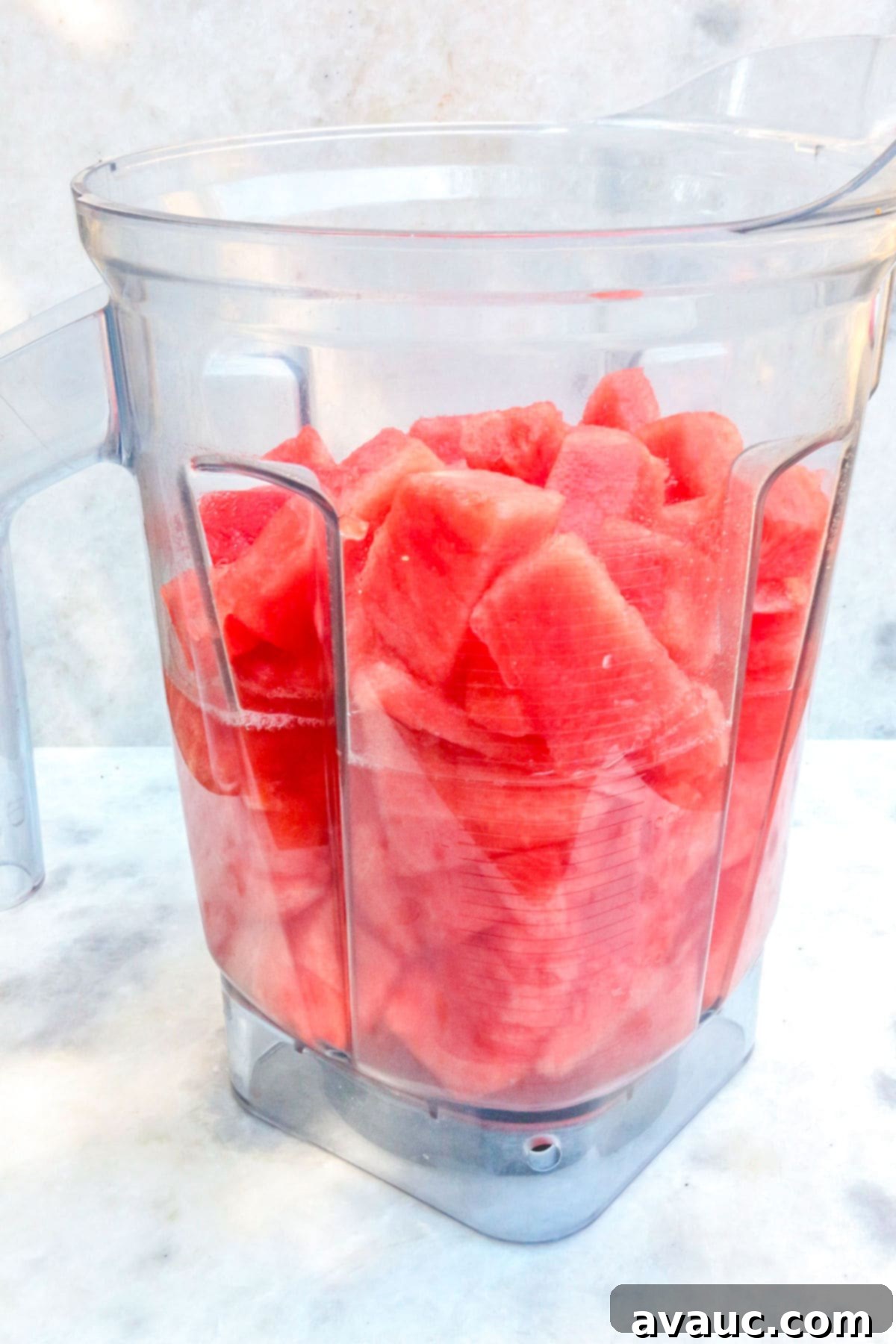 Watermelon pieces and cold water added to a blender