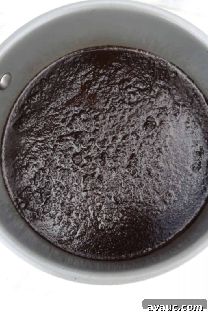 Authentic Café de Olla Recipe 5 Ground coffee on top of liquid in a small pot