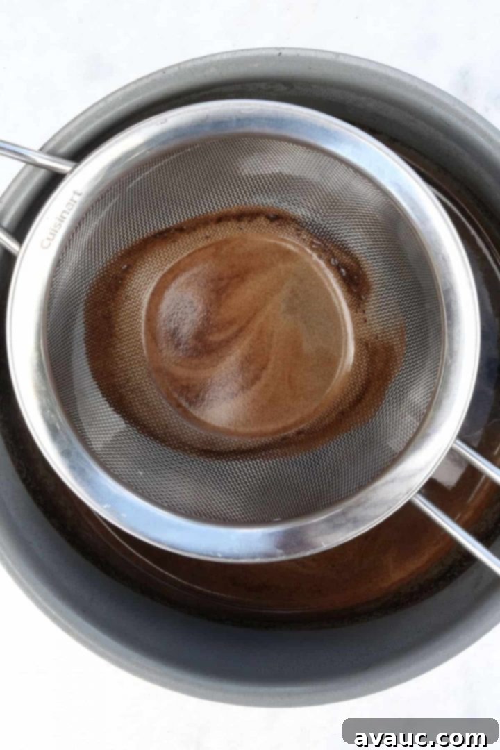 Authentic Café de Olla Recipe 6 Strainer with coffee on top of a small pot