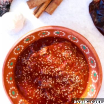 A Gluten-Free Take on Mole Poblano 9 Bowl of mole with dried chiles, cinnamon sticks, sesame seeds and garlic in the background