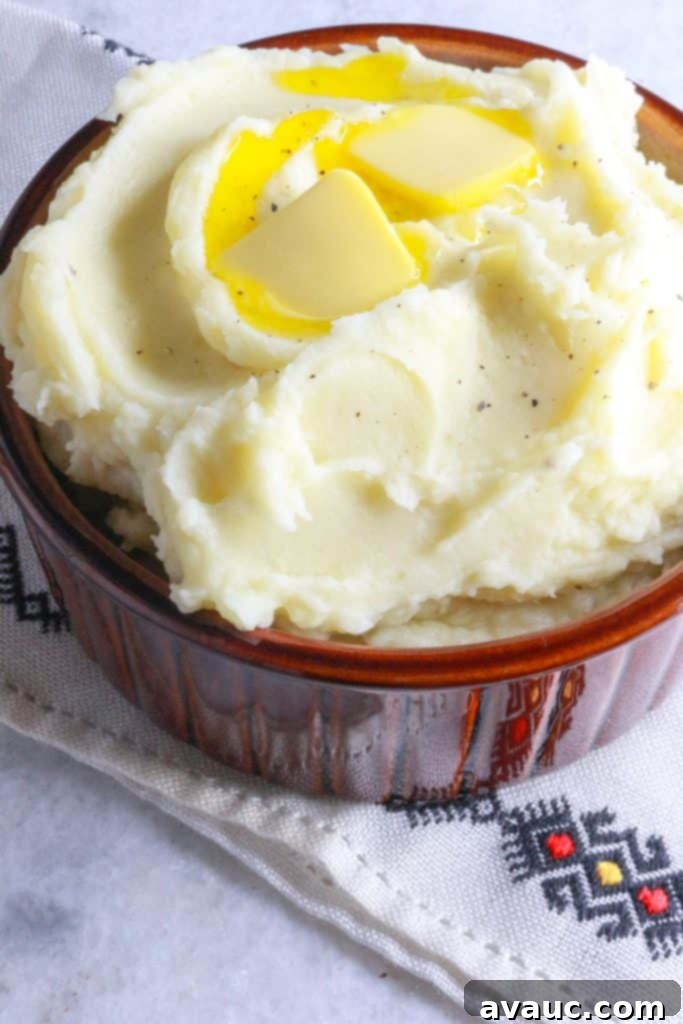Creamy Instant Pot Garlic Mash 9 Heaping bowl of Instant Pot garlic mashed potatoes with two pats of butter on top