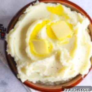 Creamy Instant Pot Garlic Mash 10 Heaping bowl of Instant Pot garlic mashed potatoes with two pats of butter on top