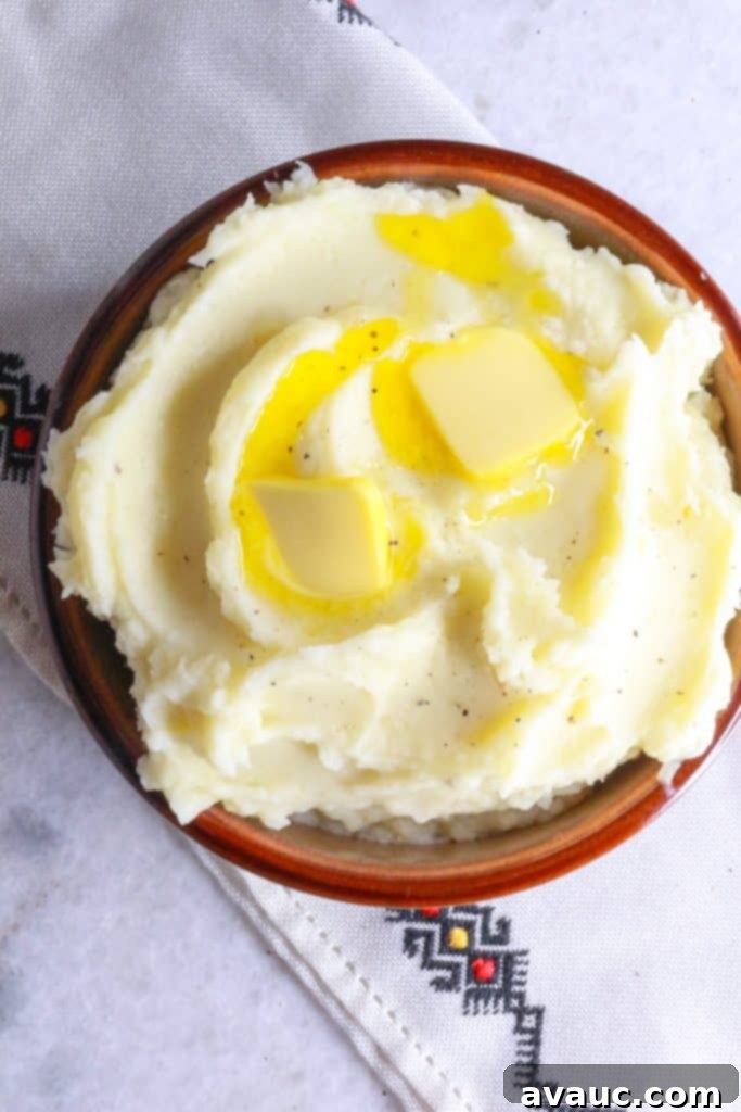 Creamy Instant Pot Garlic Mash 2 Heaping bowl of Instant Pot garlic mashed potatoes with two pats of butter on top