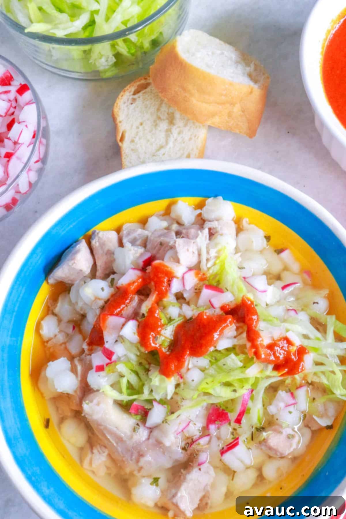 Hearty White Pozole 14 Bowl of pozole blanco with a drizzle of red chile sauce