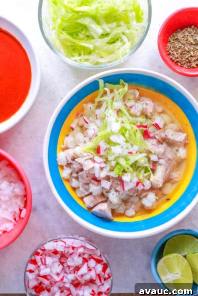 Hearty White Pozole 2 Bowl of Pozole Blanco with garnishes surrounded by small bowls with various garnishes