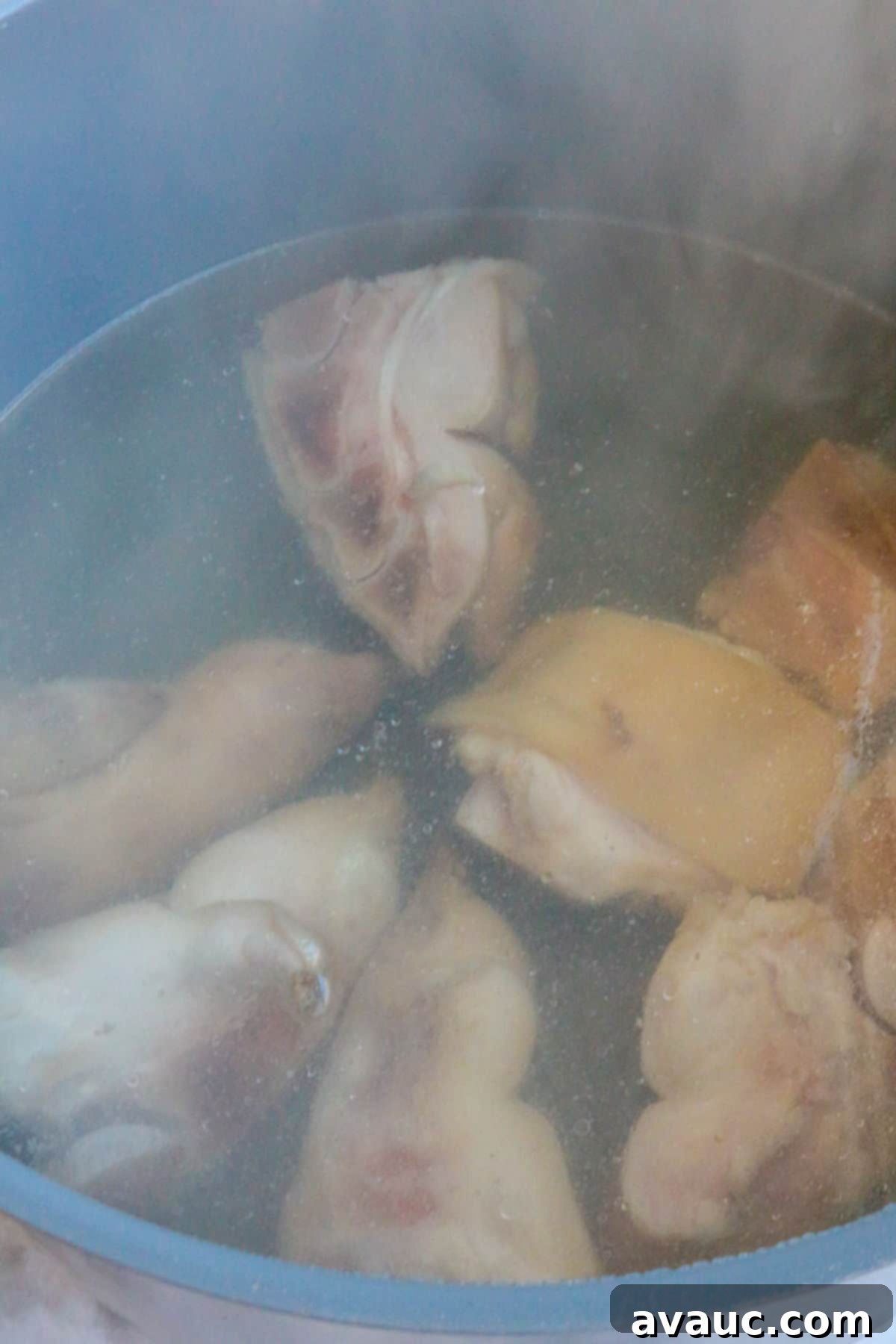 Hearty White Pozole 6 Pigs' feet boiling in water