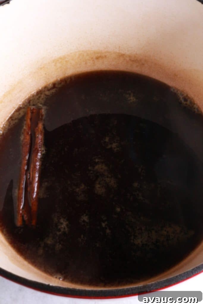 Authentic Mexican Champurrado 5 Water boiling with cinnamon stick and piloncillo