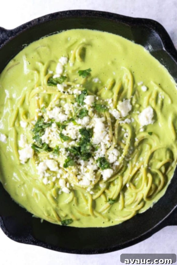 Mexican Green Spaghetti 2 Espagueti Verde in a black pan, garnished with crumbled queso fresco and fresh cilantro leaves