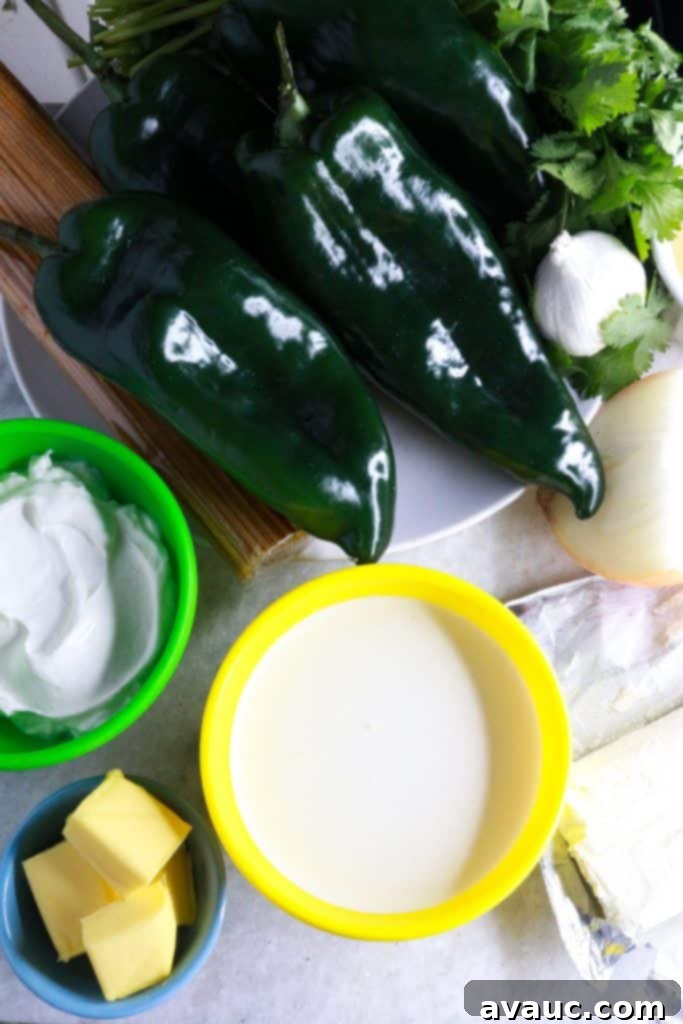 Mexican Green Spaghetti 3 Collection of fresh ingredients for Espagueti Verde, including vibrant poblano and jalapeño peppers, aromatic cilantro, diced onion, fresh garlic, and cream cheese, ready for preparation.