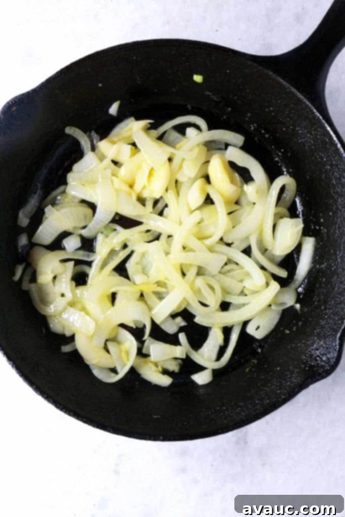 Mexican Green Spaghetti 5 Sautéed diced onions and minced garlic in a cast-iron skillet, becoming soft and fragrant, forming the base of the sauce