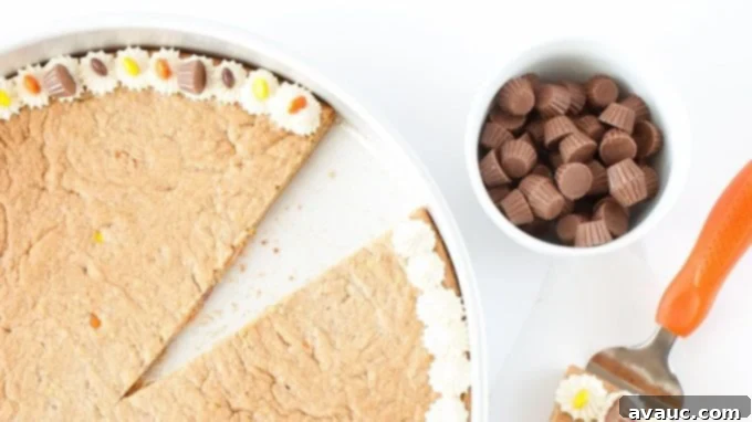 Top-down shot of the finished Reese's Peanut Butter Cookie Cake, sliced and ready to serve.