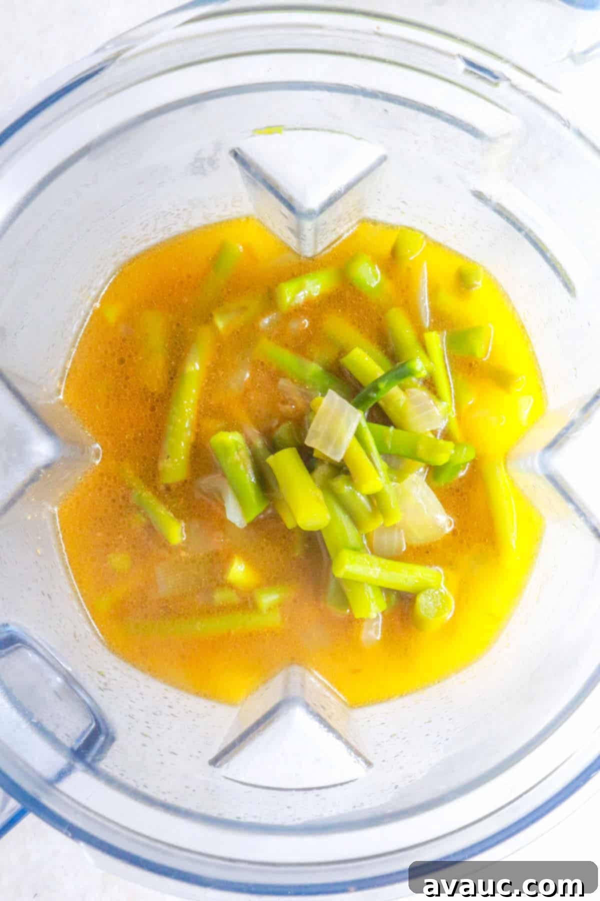 Creamy Dairy-Free Asparagus Soup 6 Blender with chopped asparagus and broth