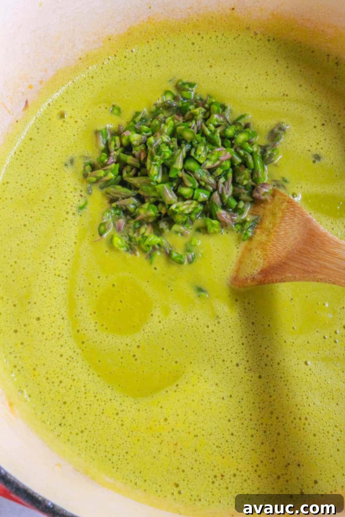 Creamy Dairy-Free Asparagus Soup 8 Adding diced asparagus to a pot of cream of asparagus soup