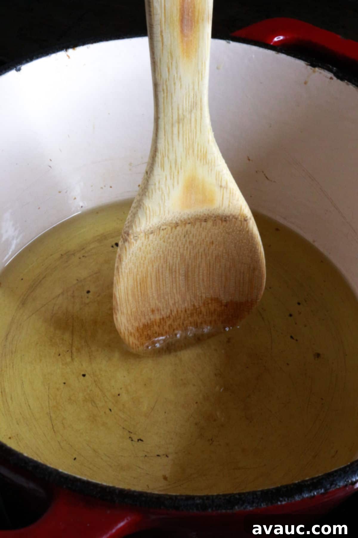 Homemade Tostada Shells Made Easy 4 Wooden spoon dipped in hot oil, showing small bubbles as a temperature test