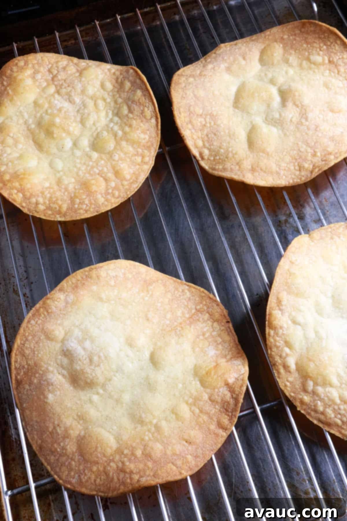 Homemade Tostada Shells Made Easy 9 Four golden-brown, crispy baked tostada shells cooling on a wire rack