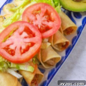 Delicious Pork Flautas topped with fresh lettuce and tomato