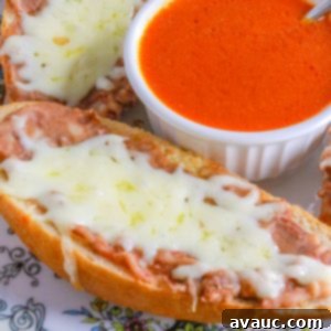 Homemade Mexican Molletes 12 Cheesy molletes Mexicanos on a plate with a bowl of chipotle sauce in the middle