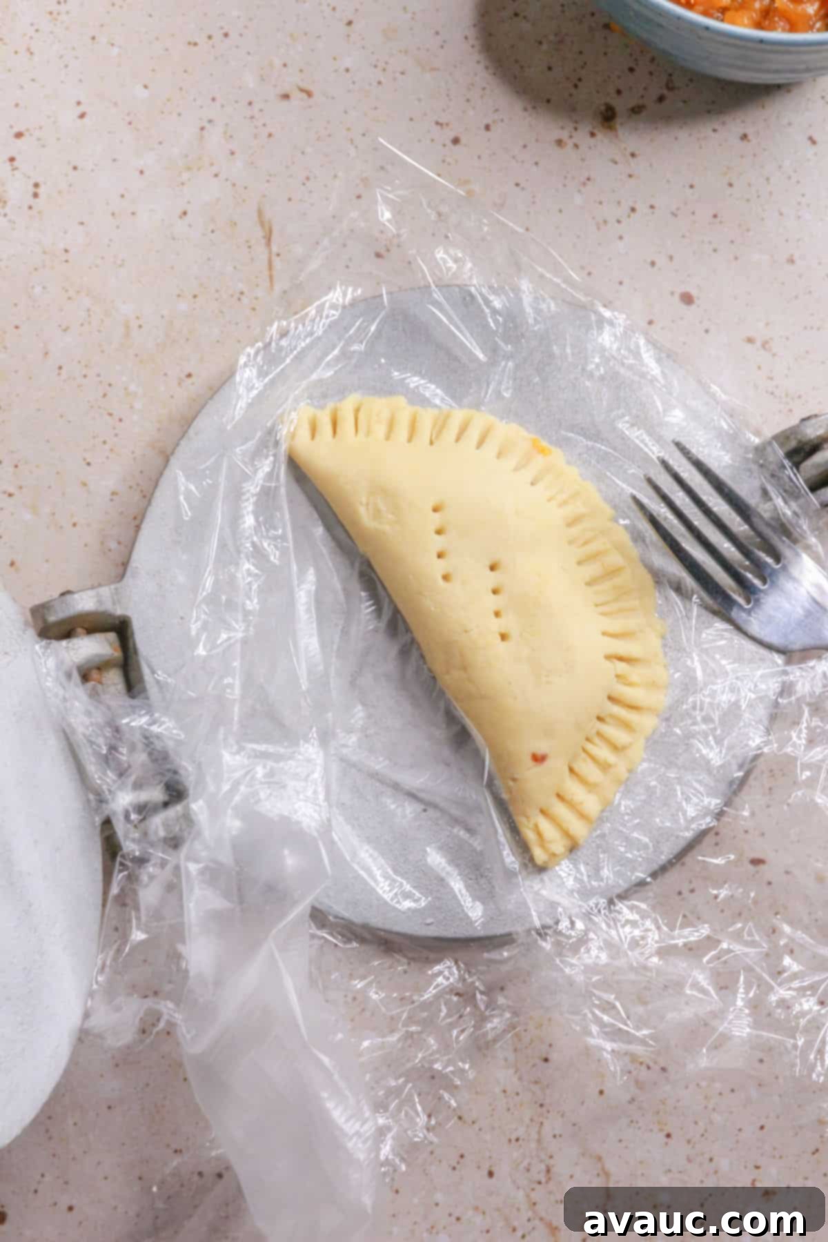 Delightful Gluten-Free Pineapple Empanadas 12 Filling and sealing empanada dough with pineapple filling