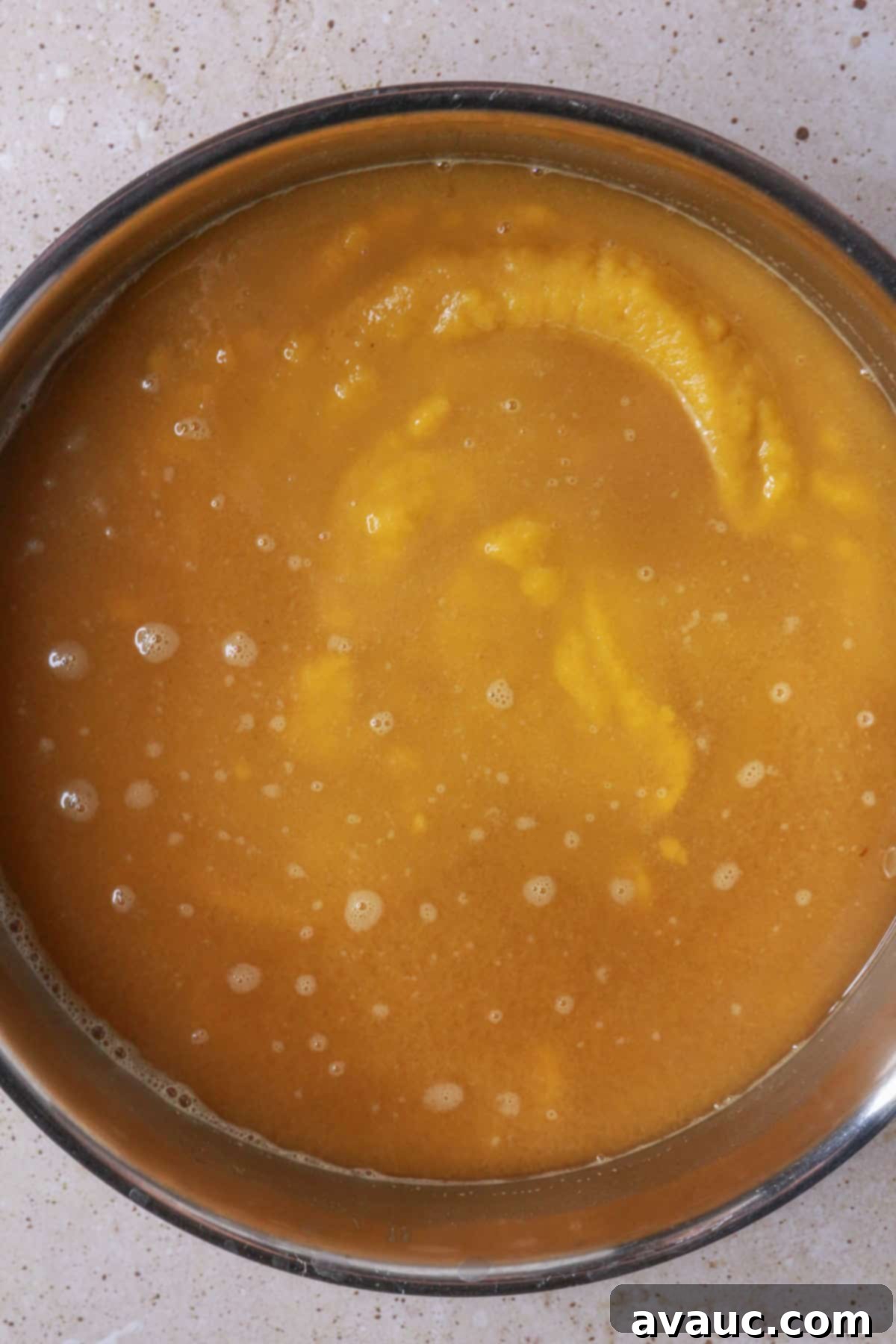 pumpkin puree mixture mixed into the pan with cinnamon water