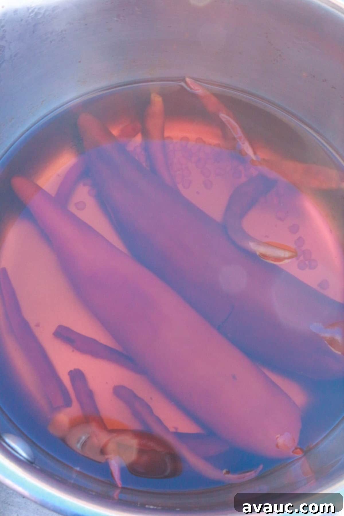 Boiling arbol and guajillo chiles in a pot with water